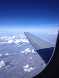 Cropped image of airplane wing over landscape