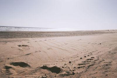 Scenic view of beach against clear sky