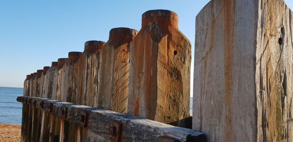 Wooden posts on beach