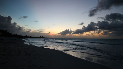 Scenic view of beach against sky during sunset