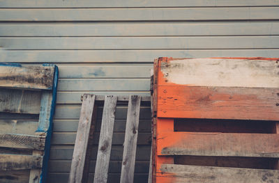 Close-up of wooden crates against wall