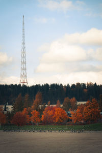 Trees and tower against sky during autumn