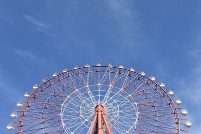 Low angle view of ferris wheel against blue sky