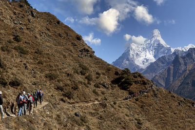 Trekking tourists overlooking mount ama dablam, khumbu region, nepal