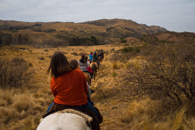 People riding horses on land