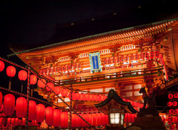 Low angle view of illuminated lanterns hanging in building at night
