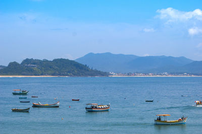 Boats in sea against sky