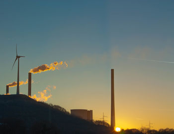 Low angle view of windmill against sky during sunset