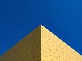 Low angle view of building against clear blue sky