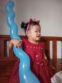 Portrait of cute girl playing with balloons