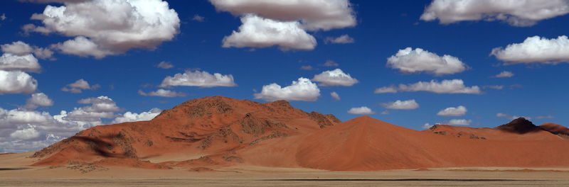 Scenic view of mountains against cloudy sky