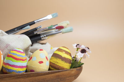 Close-up of multi colored easter eggs and paintbrush. 