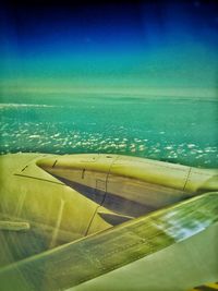 Cropped image of airplane over sea