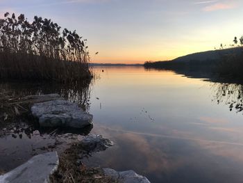 Scenic view of lake against sky during sunset