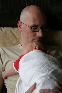 Close-up of man wearing eyeglasses at home