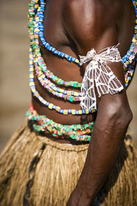 Midsection of man wearing traditional clothing