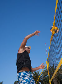 Low section of man against clear blue sky