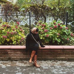 Rear view of woman standing against plants