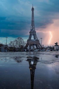Rainy weather with wind and lightning near eiffel tower.