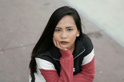 Portrait of woman on footpath