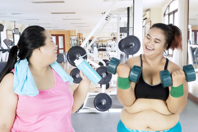 Female friends exercising in gym