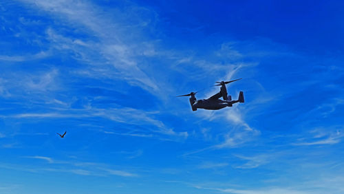 Low angle view of helicopter flying in sky