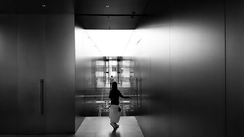 Silhouette of woman in corridor