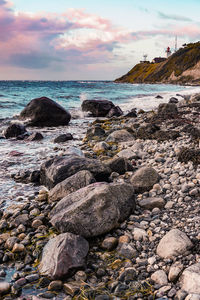 Rocks on beach against sky