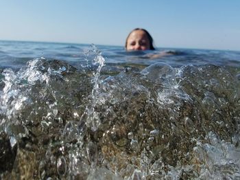 Surface level of girl swimming in sea