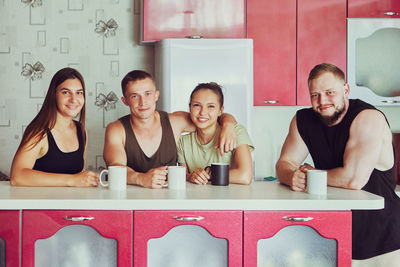 Portrait of smiling family sitting at home