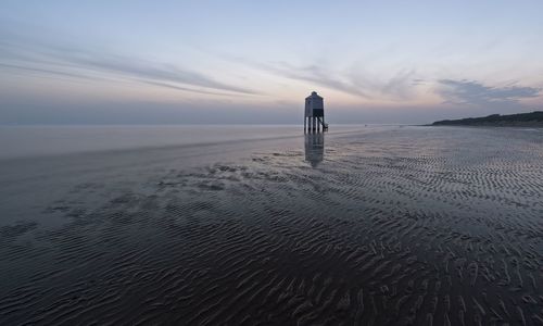 Scenic view of beach against sky during sunset