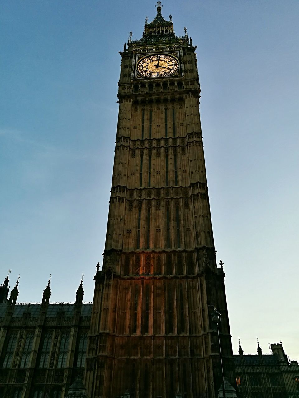 LOW ANGLE VIEW OF CLOCK TOWER IN CITY AGAINST SKY