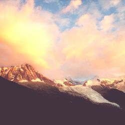 Scenic view of mountains against cloudy sky