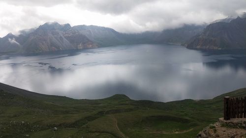 Scenic view of lake and mountains against sky