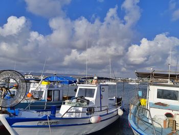 Boats moored in sea against sky