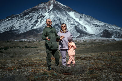 Full length of friends on snow covered mountain