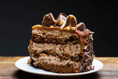 Close-up of dessert in plate on table against black background