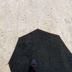 Low section of person standing on concrete floor