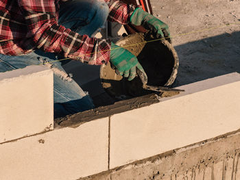 Low section of man working on sunny day