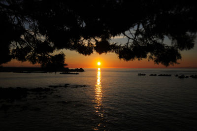 Scenic view of sea against orange sky