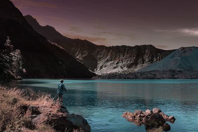 Scenic view of lake and mountains against sky