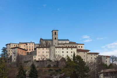 Low angle view of old building against blue sky