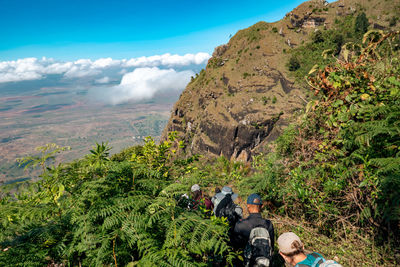 View of hikers at a  scenic lookout at kwa mkeka peak at usambara mountains, tanga region, tanzania