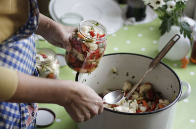 Close-up of woman preparing pickle at home