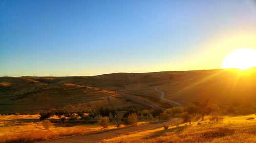 Scenic view of landscape against clear sky at morning