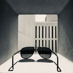 Close-up of sunglasses on wall against building