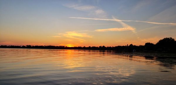 Scenic view of lake against sky during sunset
