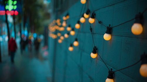 Illuminated lanterns hanging on street at night