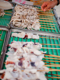 Cropped hand of person preparing food for sale at market