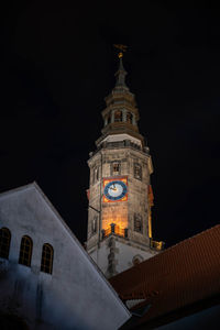 Low angle view of illuminated building against sky at night